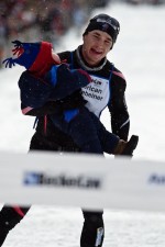 Matt Liebsch carries his son across the finish line of the 2009 American Birkebeiner