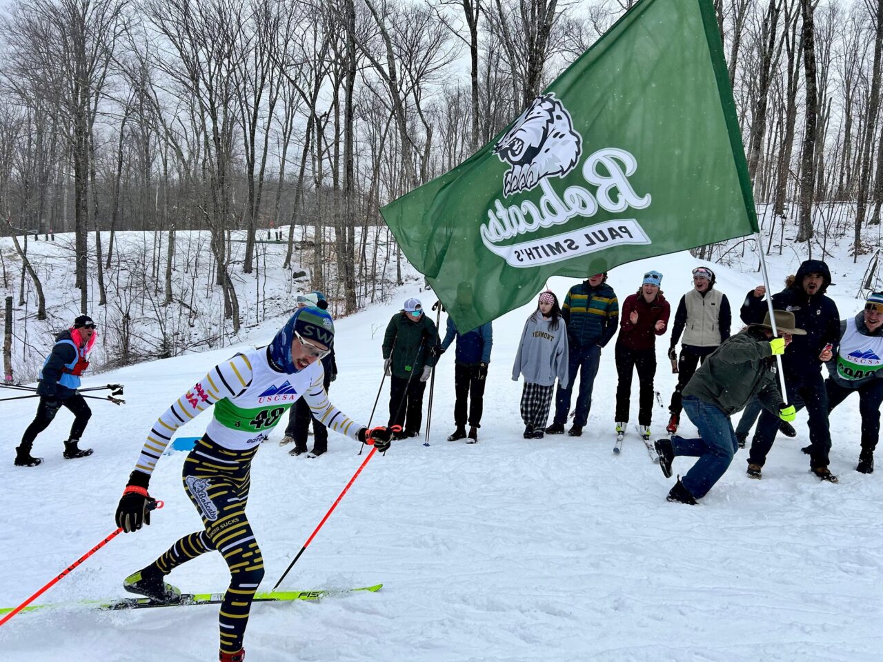 A cross-country skier races past a group